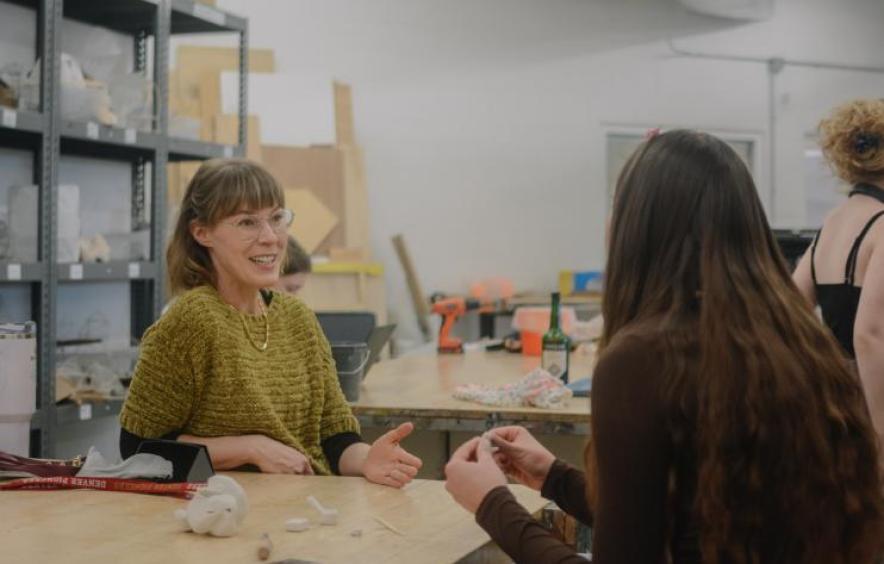 Faculty speaking with students during a studio class